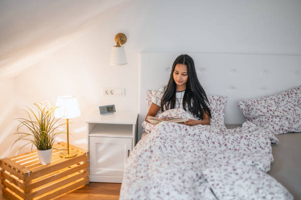 key to a healthy and happy familyYoung Indian Woman Reading In Bed